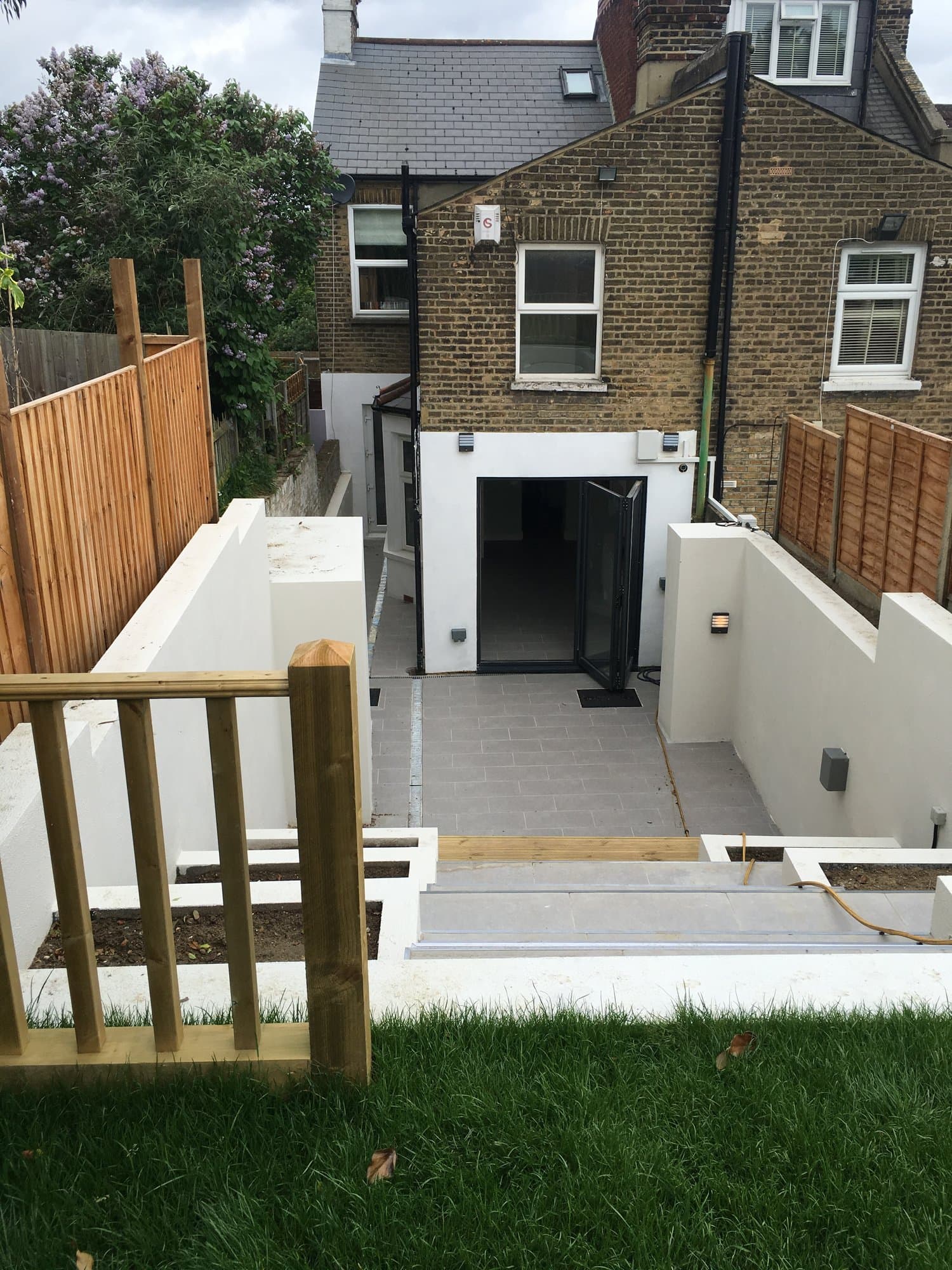 Bifolding doors and tiled patio at the rear extension