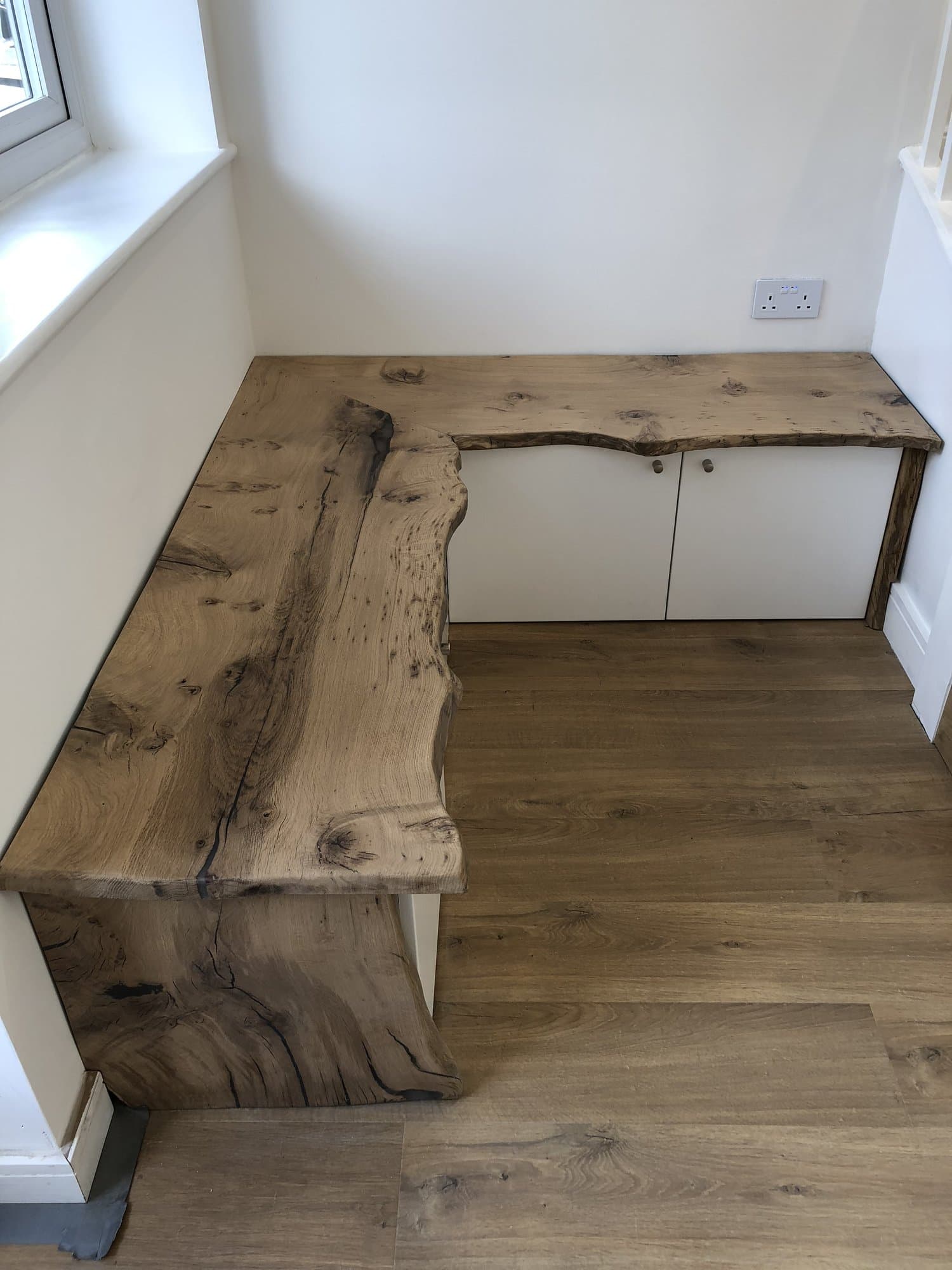 Bespoke live-edge oak joinery and built-in storage inside the garden office
