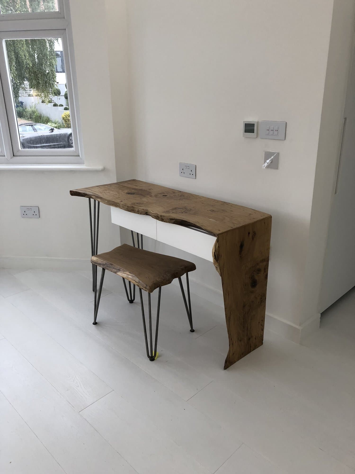 Bespoke live-edge oak table and stool inside the garden office