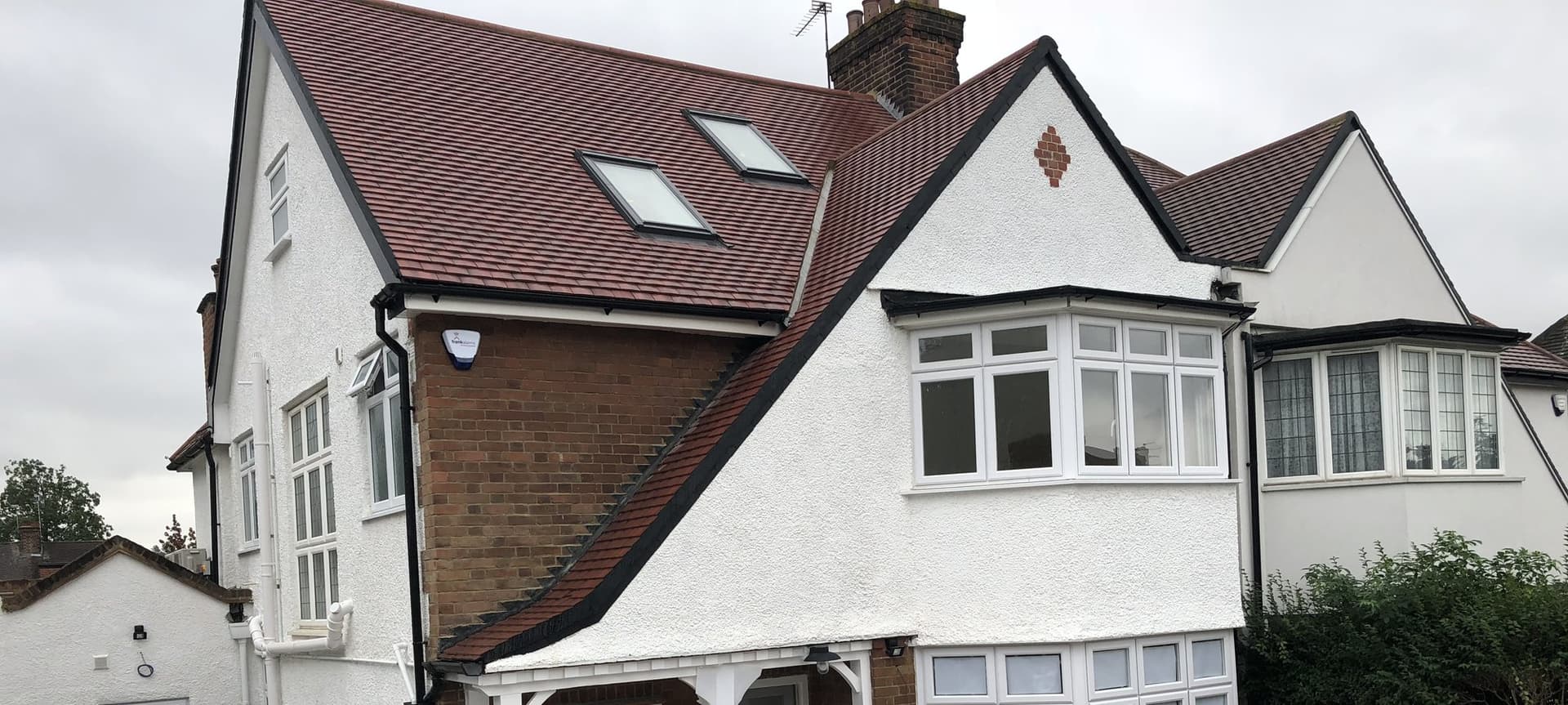 Renovated semi-detached house in Basing Hill, Hampstead with re-rendered exterior and loft conversion roof windows