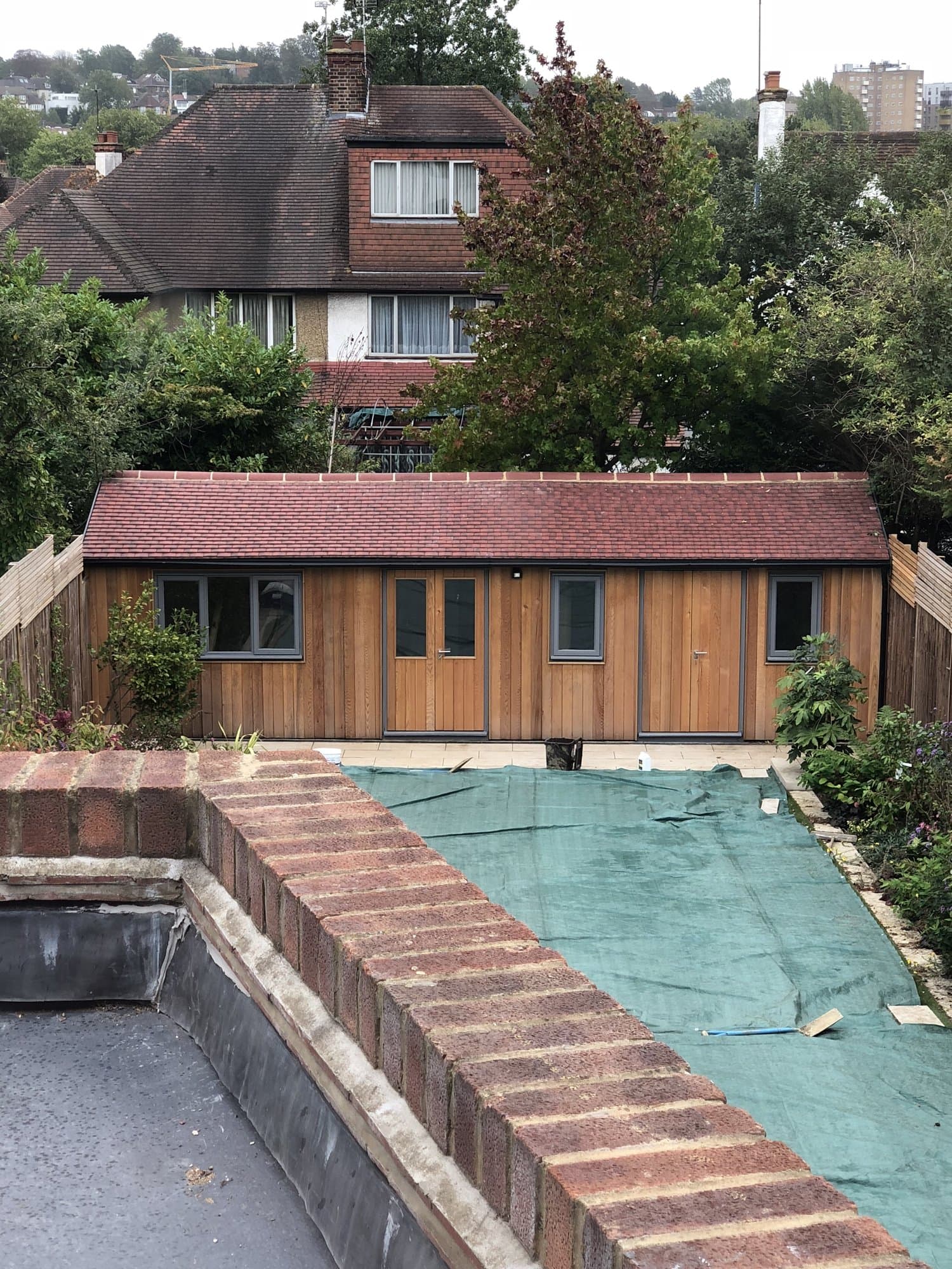 Cedar-clad garden office at the rear of the newly landscaped garden