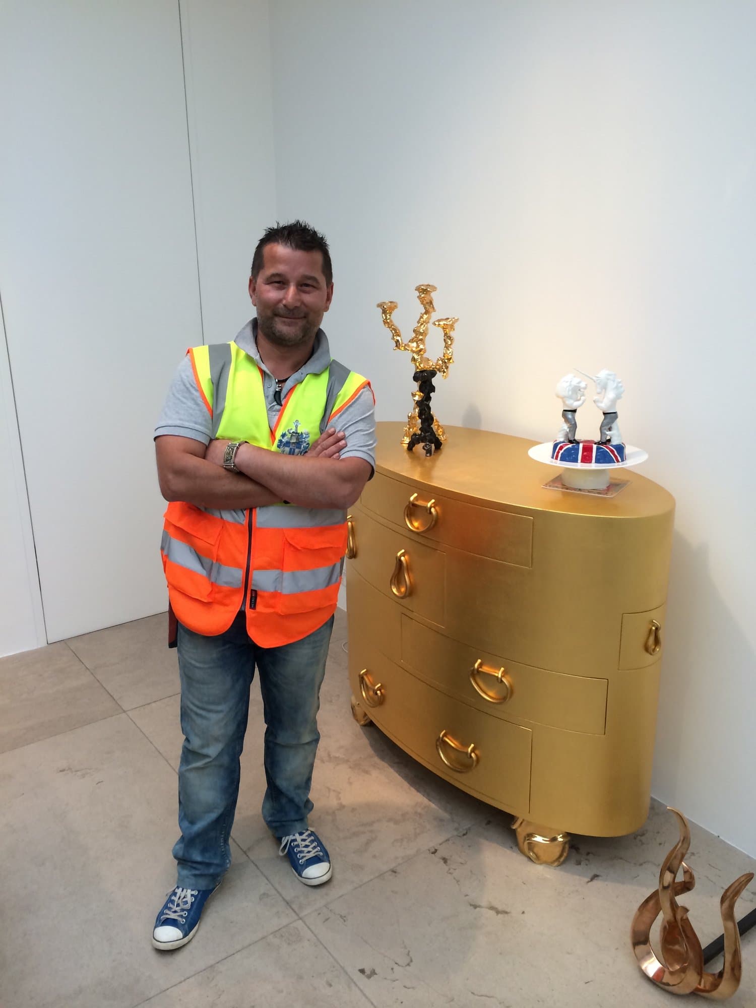 Our team handling and installing high-value gold sculptures in the gallery