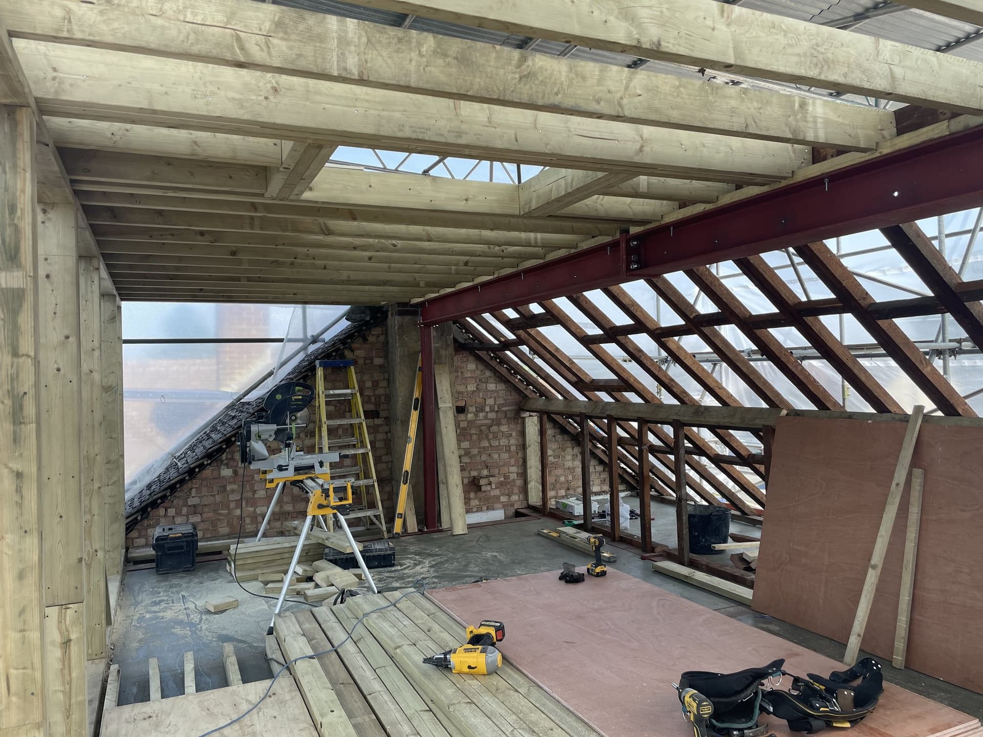 Loft conversion roof structure with steel beam and new rafters