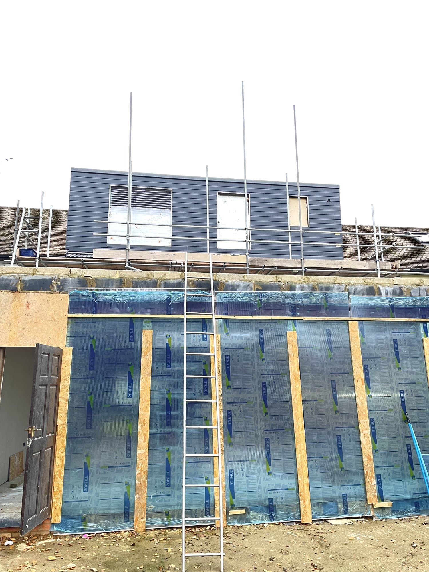 Rear extension exterior with insulation boards and composite cladding being fitted