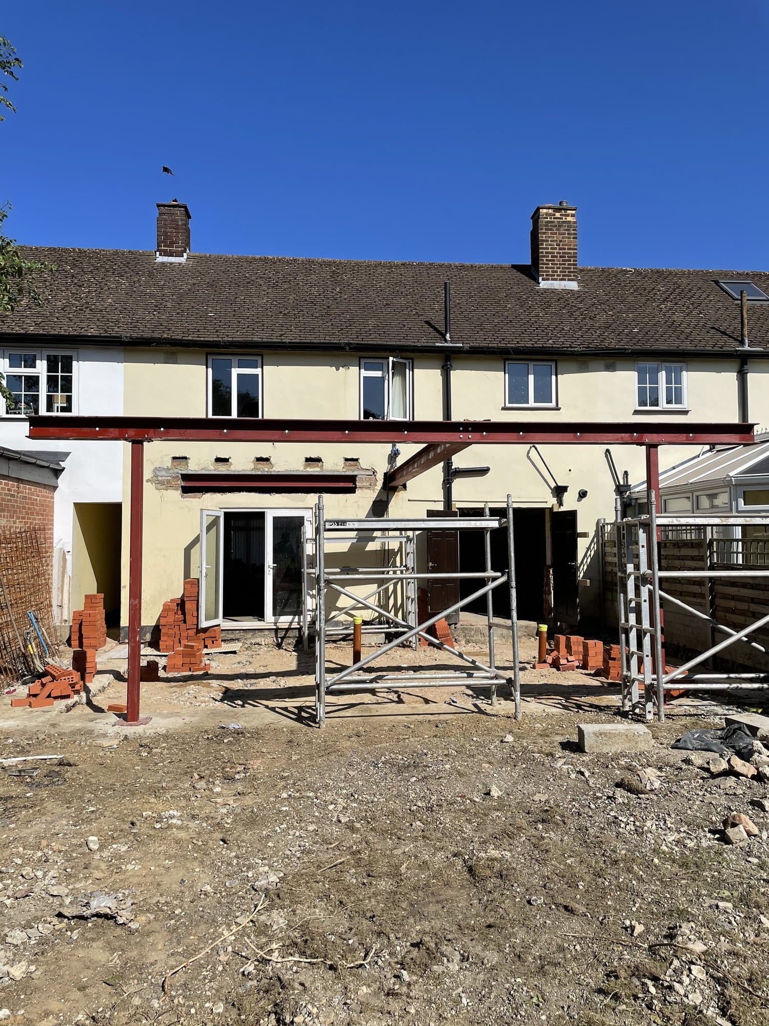 Rear of a Chigwell house during construction of a 6m extension, with new structural steelwork in place