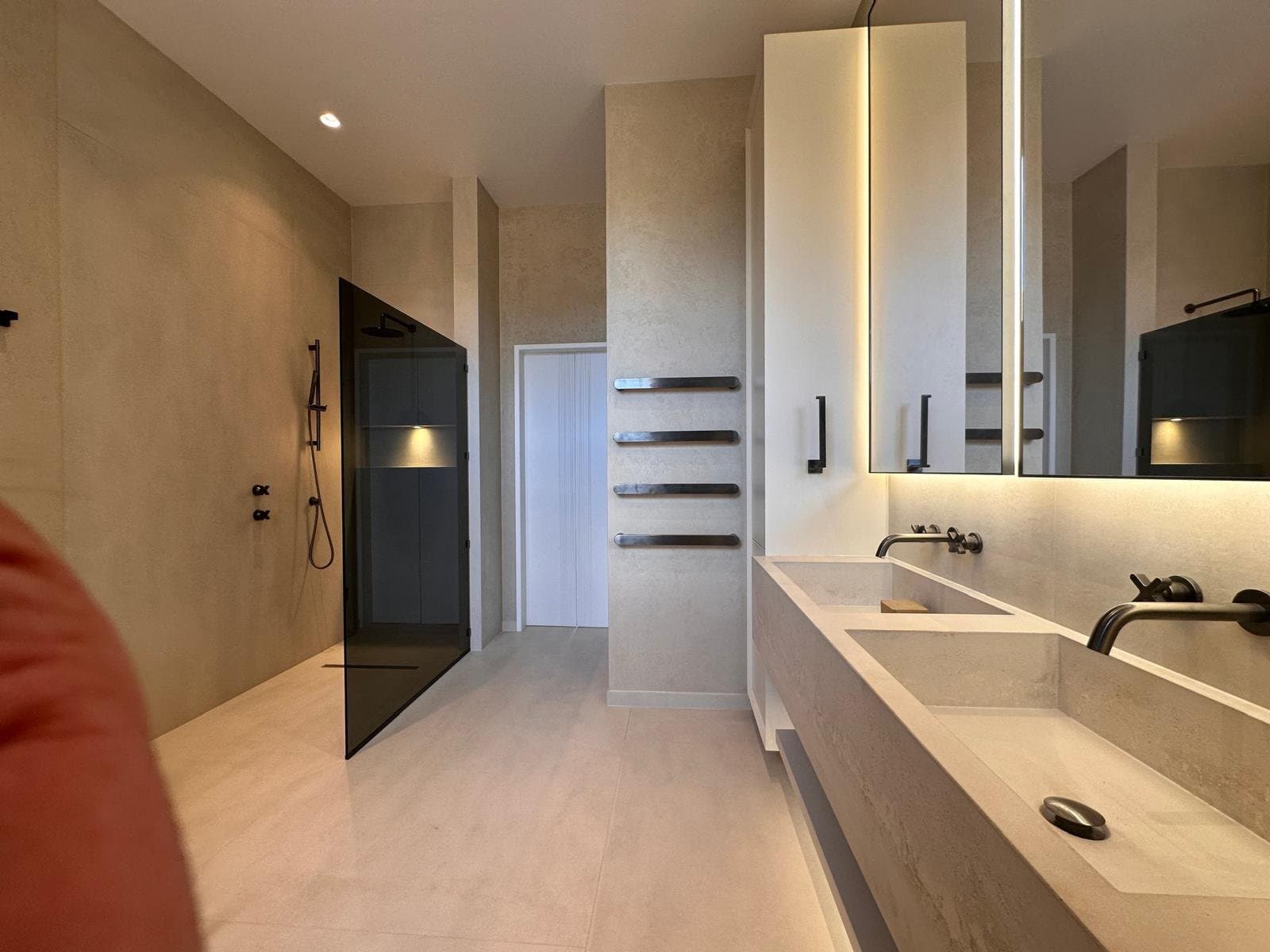 Walk-in shower and concrete-look double vanity in a contemporary bathroom