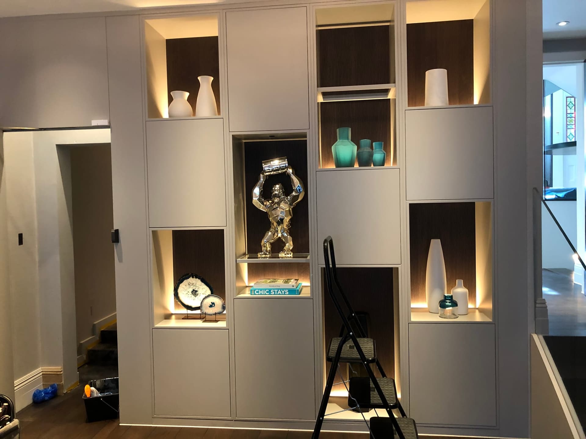 Bespoke fitted display wall unit with integrated lighting, custom-manufactured and installed