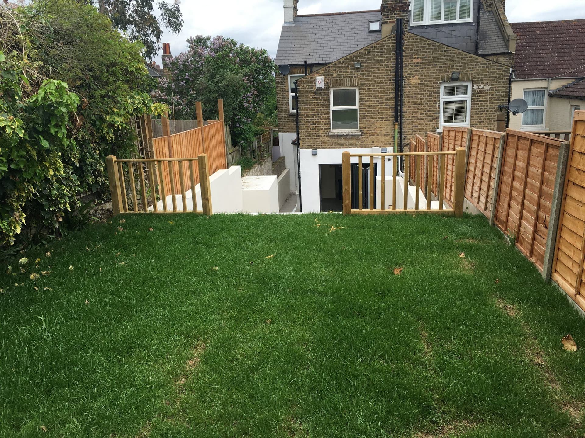 Rear lower-ground extension with bifolding doors opening onto a newly landscaped garden