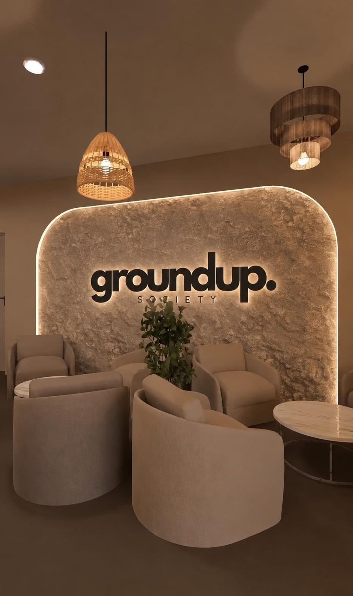 Finished branding feature wall with backlit signage, pendant lighting and seating