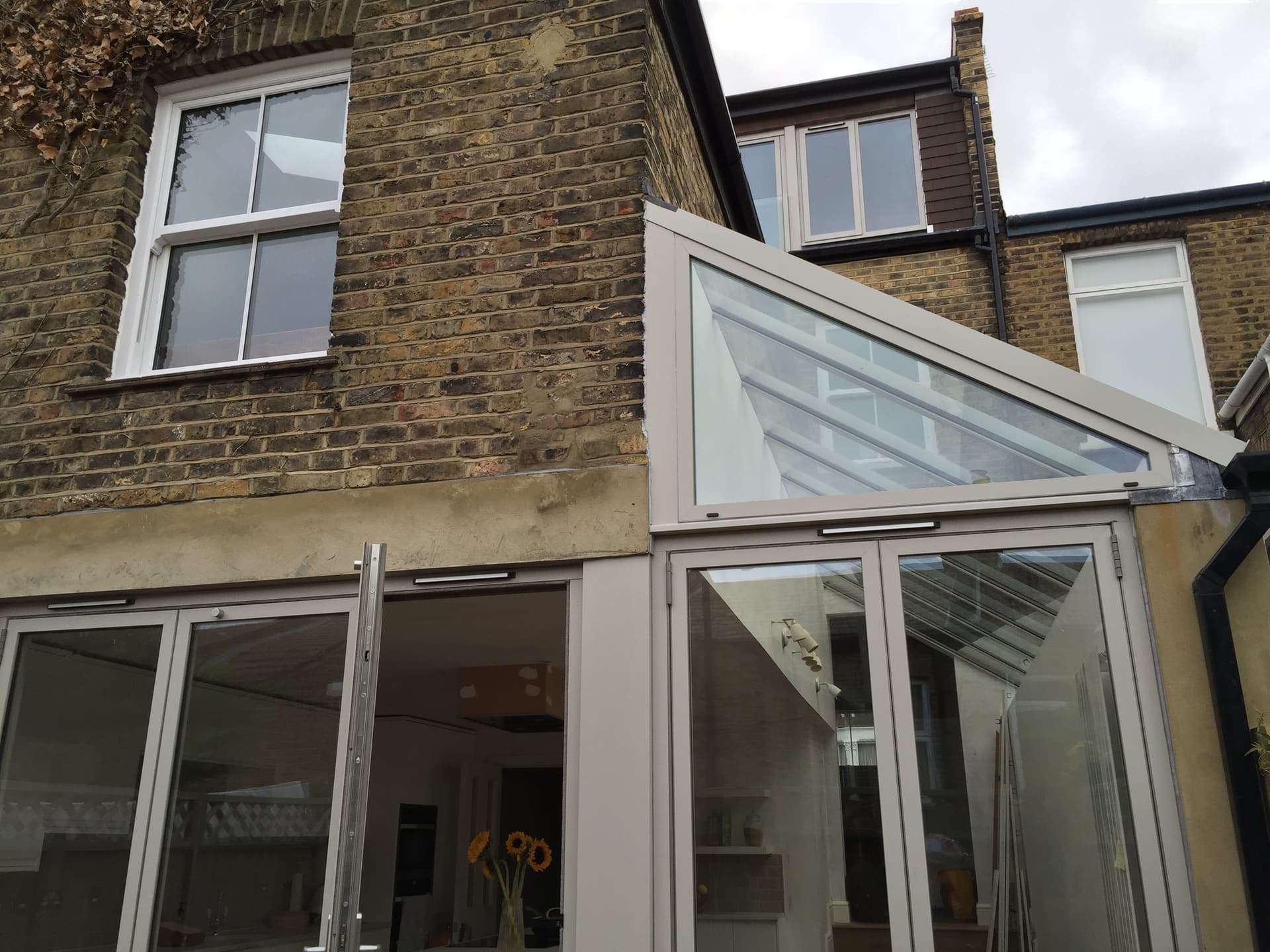 Finished glazed side extension against the original brick house on Gairloch Road