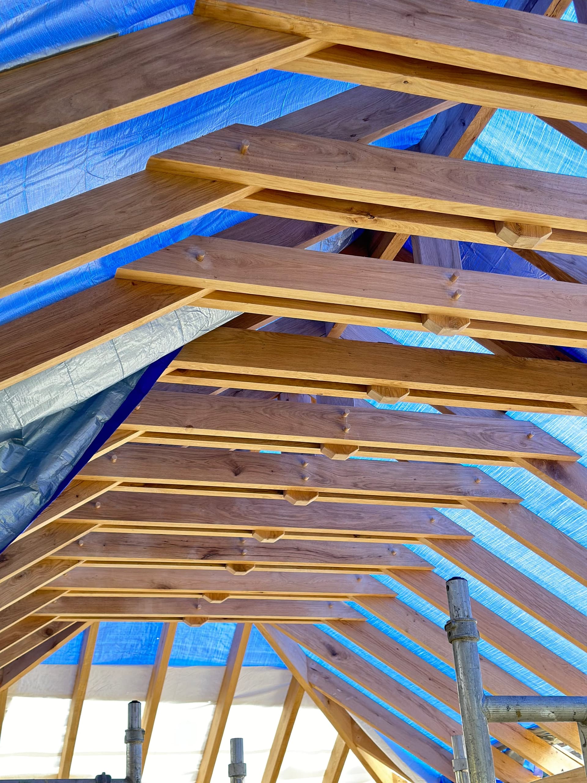 Green oak roof structure under construction, showing the jointed rafters