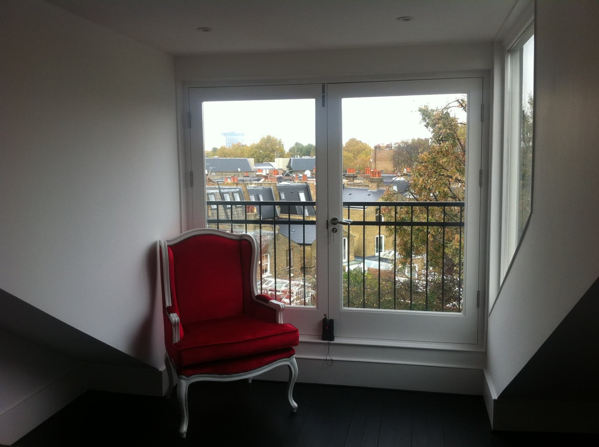 Loft conversion bedroom with Juliet balcony overlooking the rooftops
