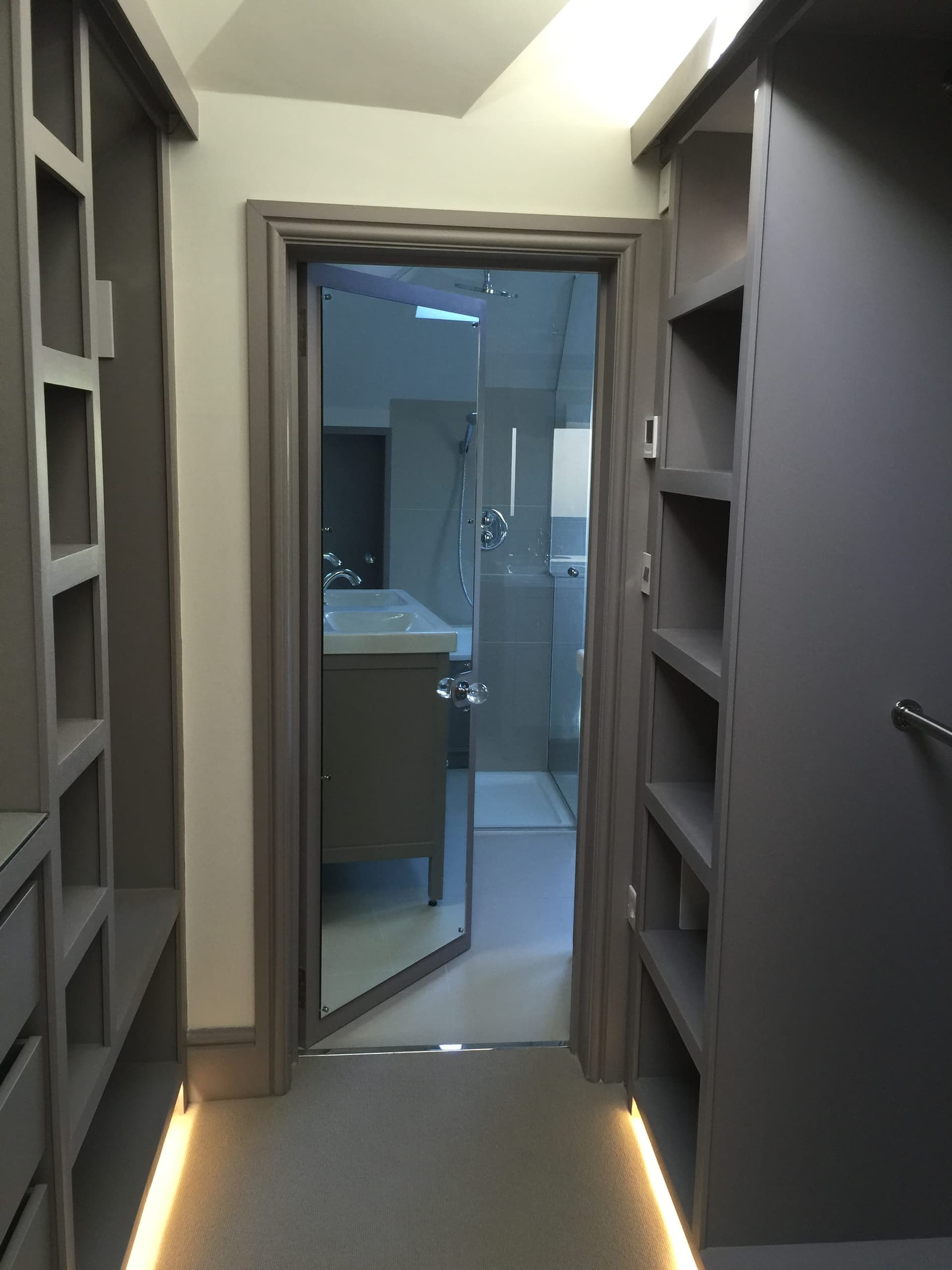 Loft en-suite bathroom with a glass shower partition
