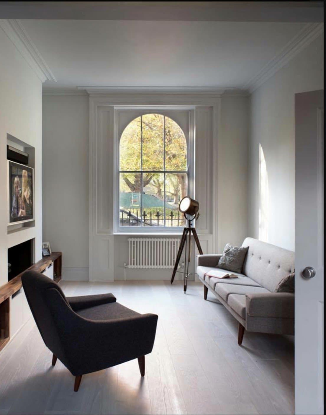 Front reception room with restored sash window and hardwood flooring