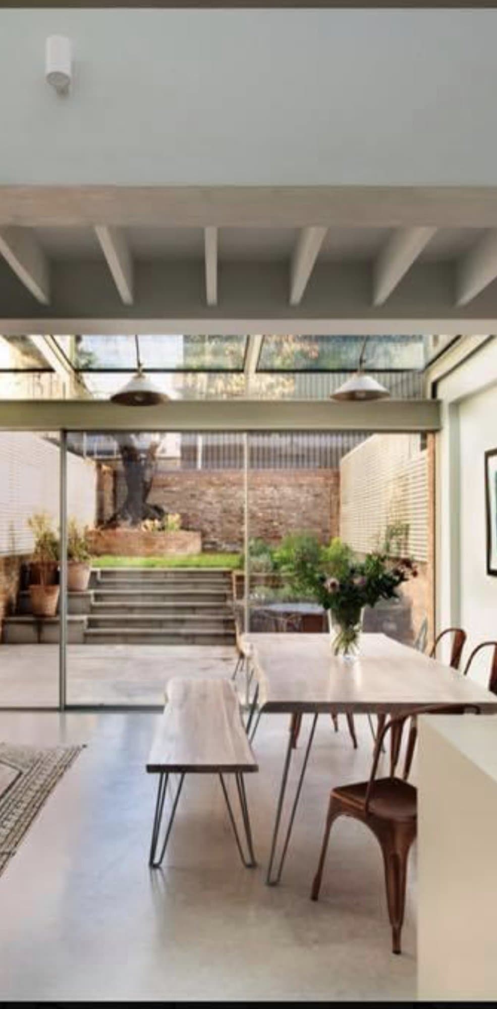 Dining area within the glazed extension looking out to the courtyard garden