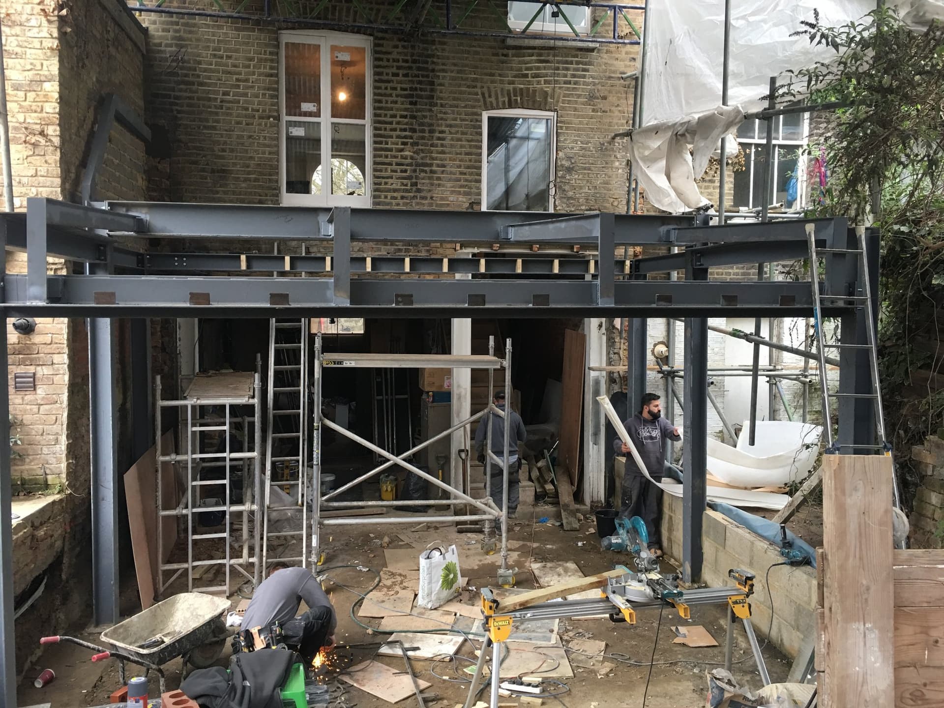 The site team installing the steel frame for the rear glass extension