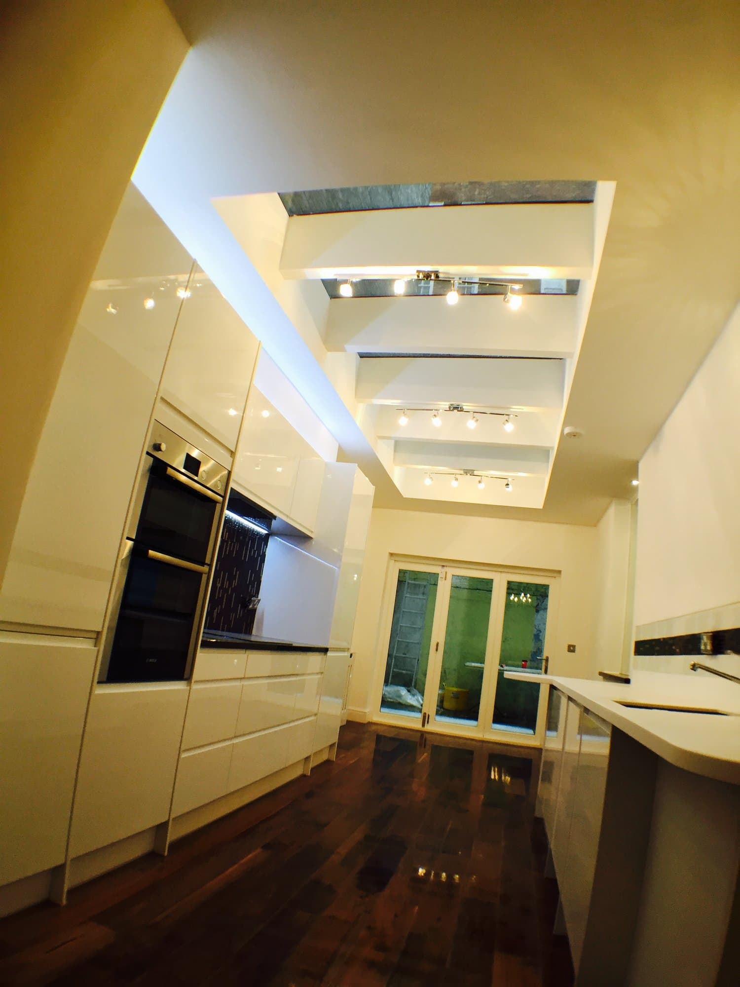 Recessed ceiling lighting detail above the kitchen, with bifold doors to the rear