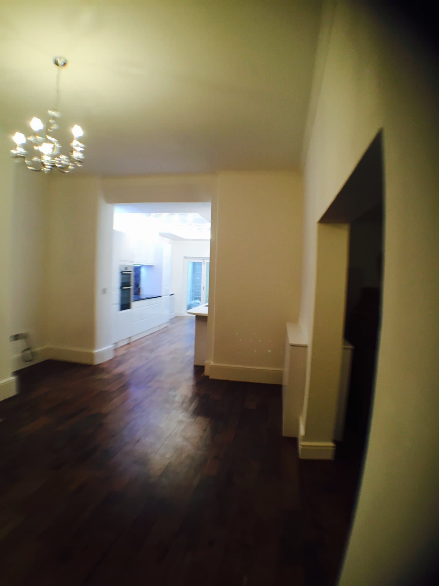 Open-plan reception room leading through to the remodelled kitchen
