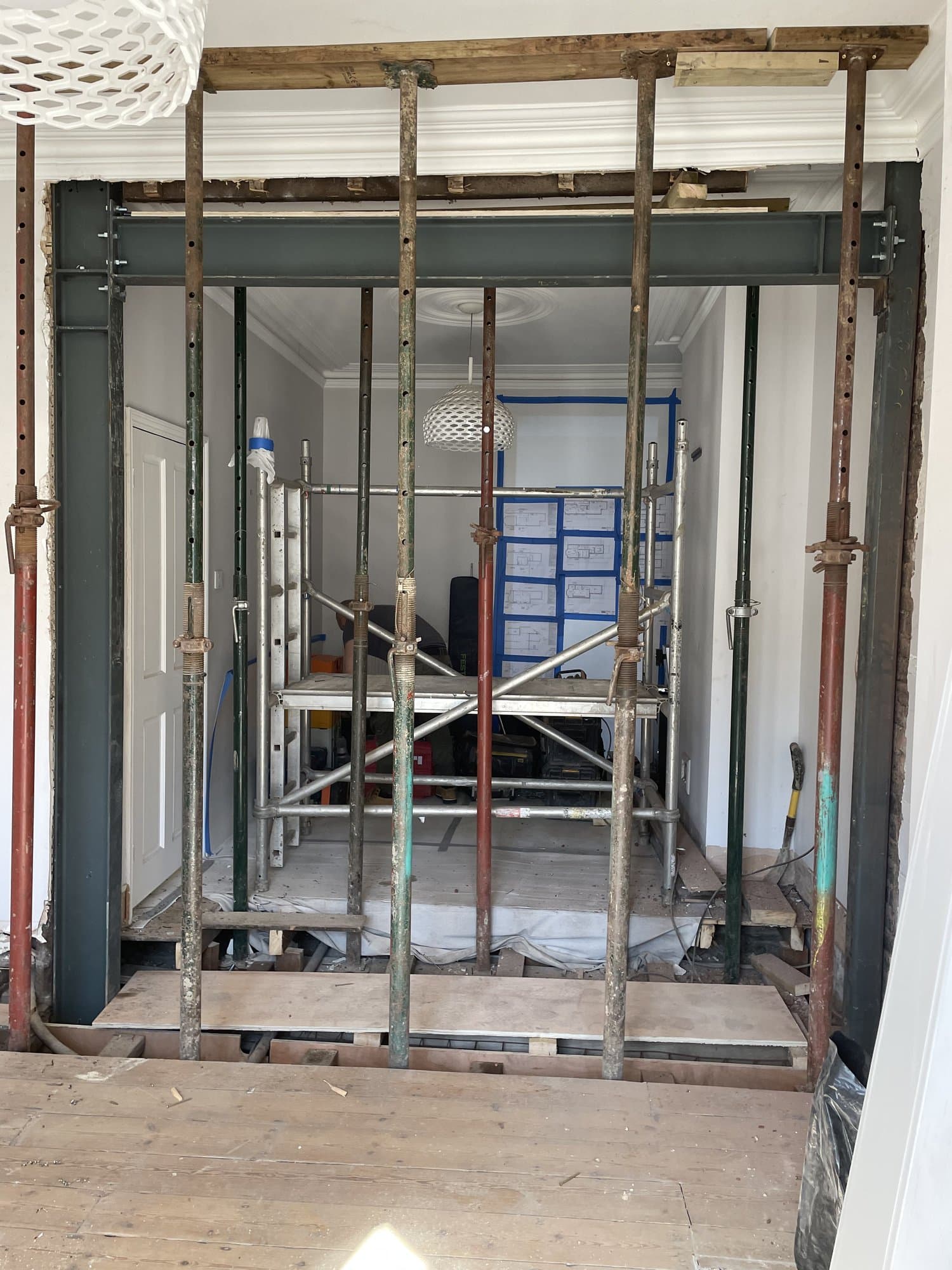 Structural steel beam installed during the renovation, supported on acrow props