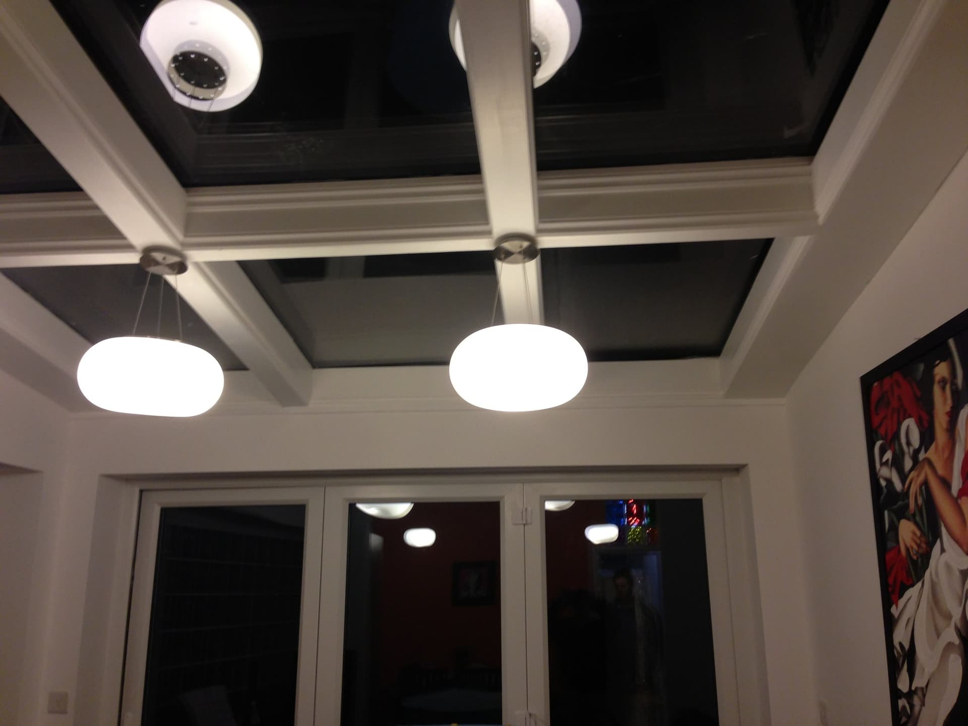 Vaulted, part-glazed roof of a kitchen extension with pendant lighting