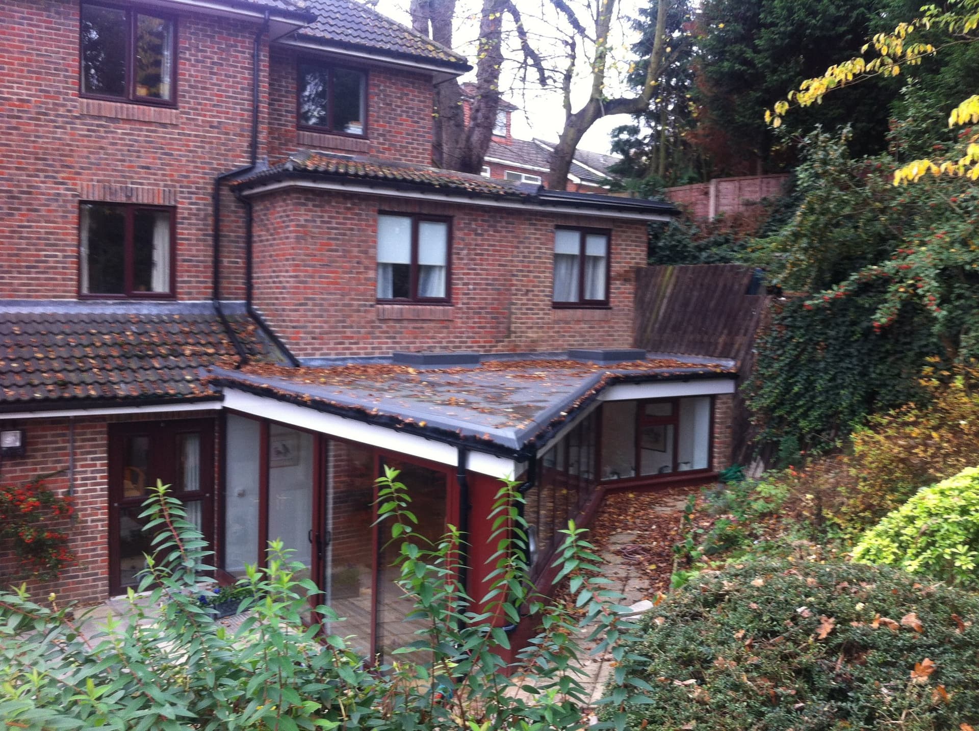 Rear elevation of the care home showing the ground floor extension against the sloped garden