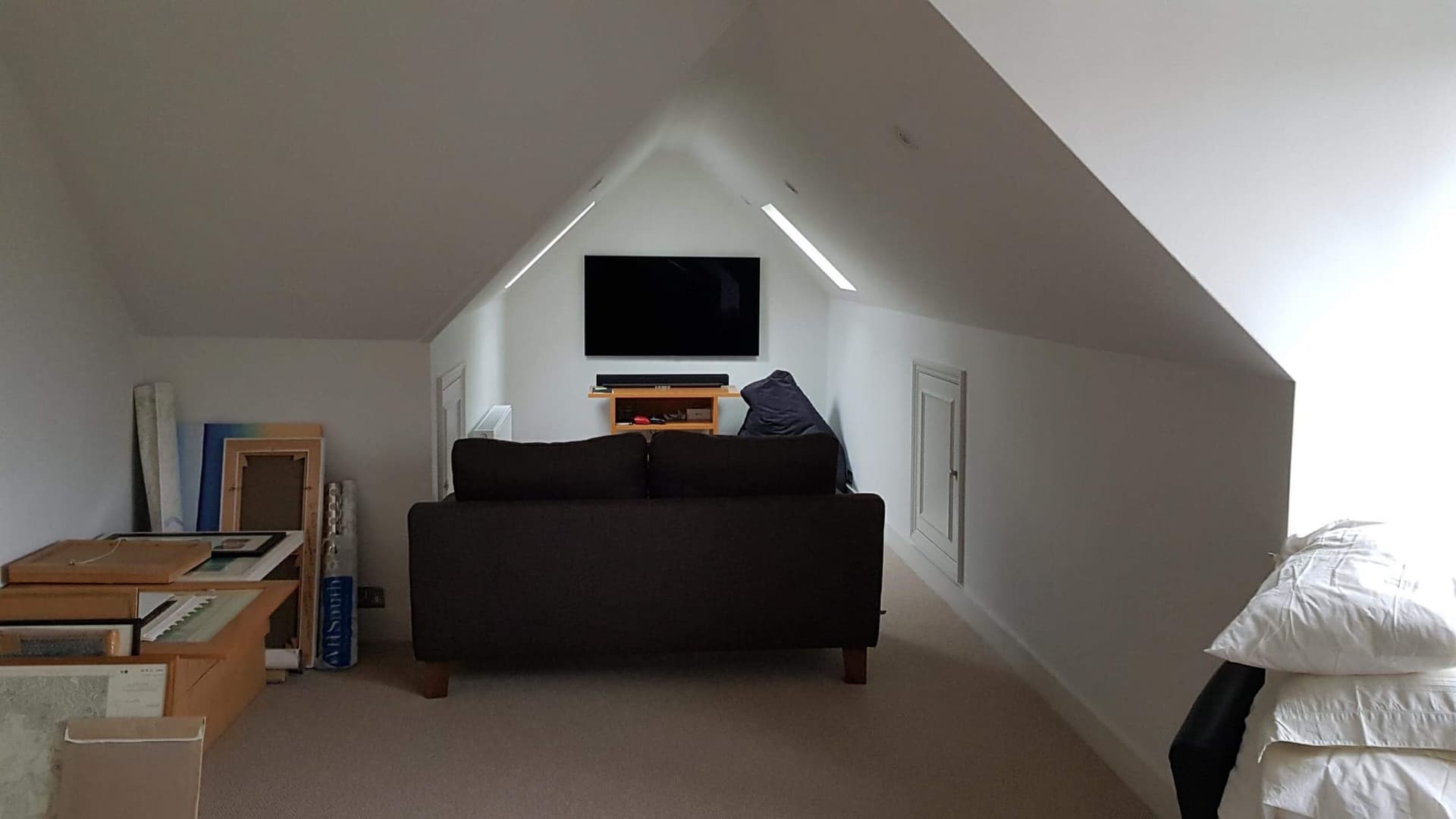 Upper floor lounge in the new wing with a sloped ceiling and skylights