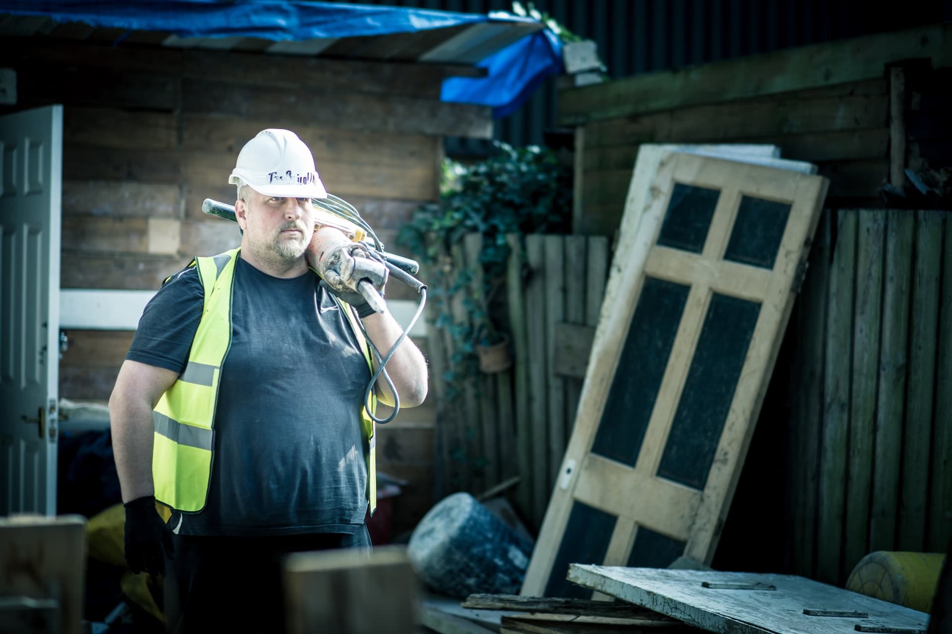 A TopBuild UK team member carrying a breaker between jobs