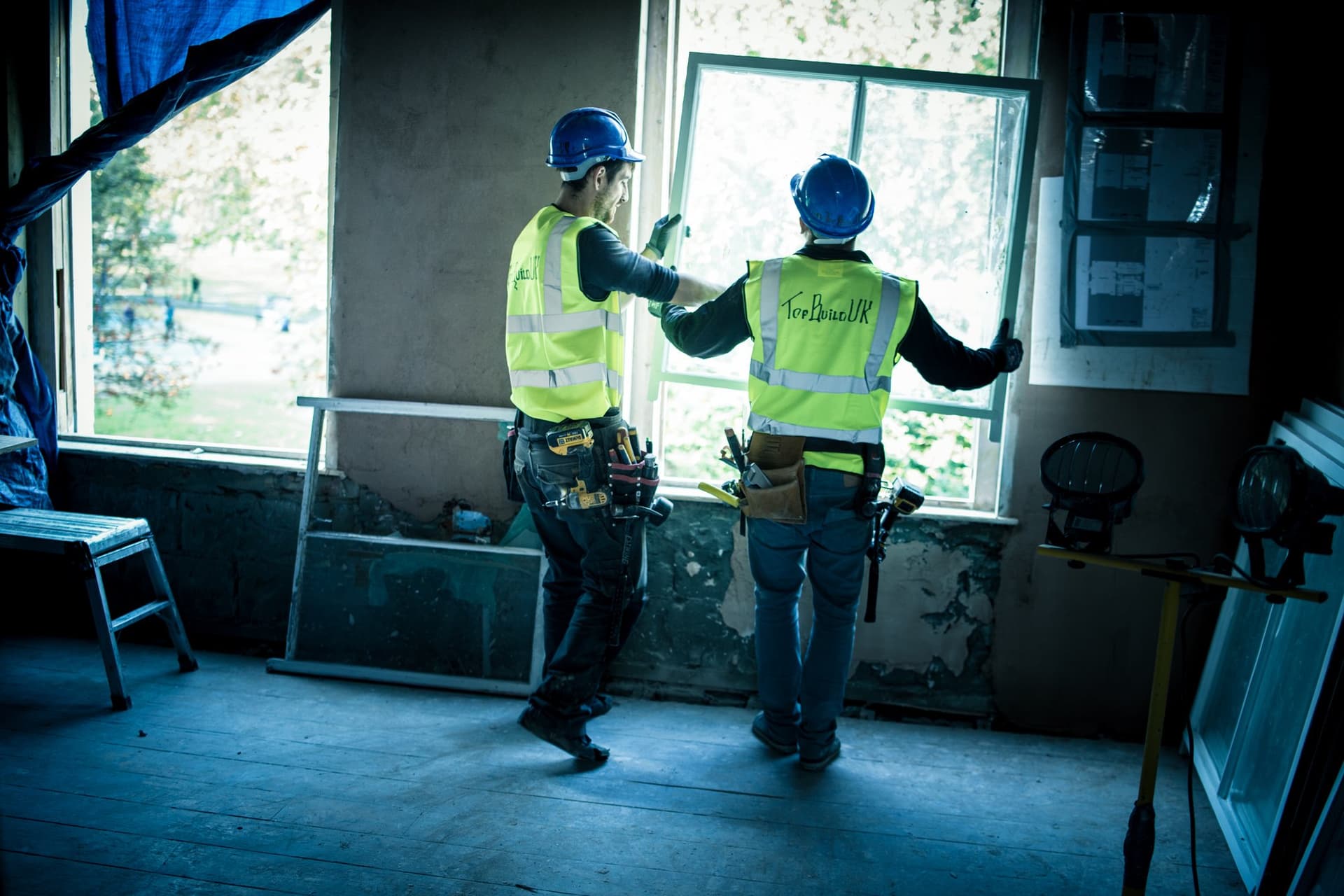 Two TopBuild UK team members fitting a window on site